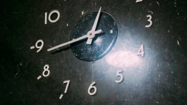 Picture of the bottom part of a clock with the 11, 12, 1 and 2 not visible. Short hand is pointing between 12 and 1 and long hand is pointed at about 43 minutes.